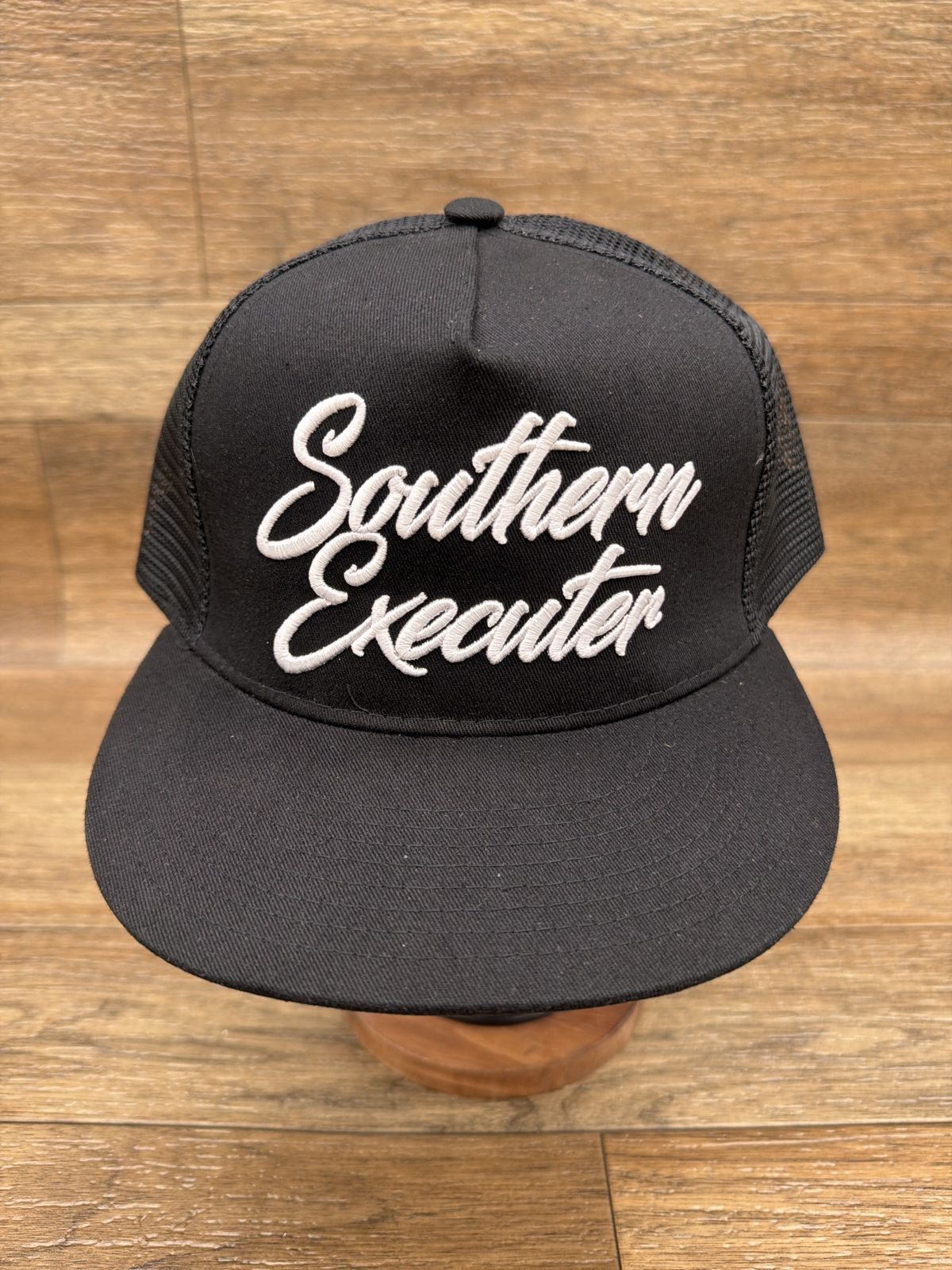 Script logo flat brim trucker cap in Black by Southern Executer, front