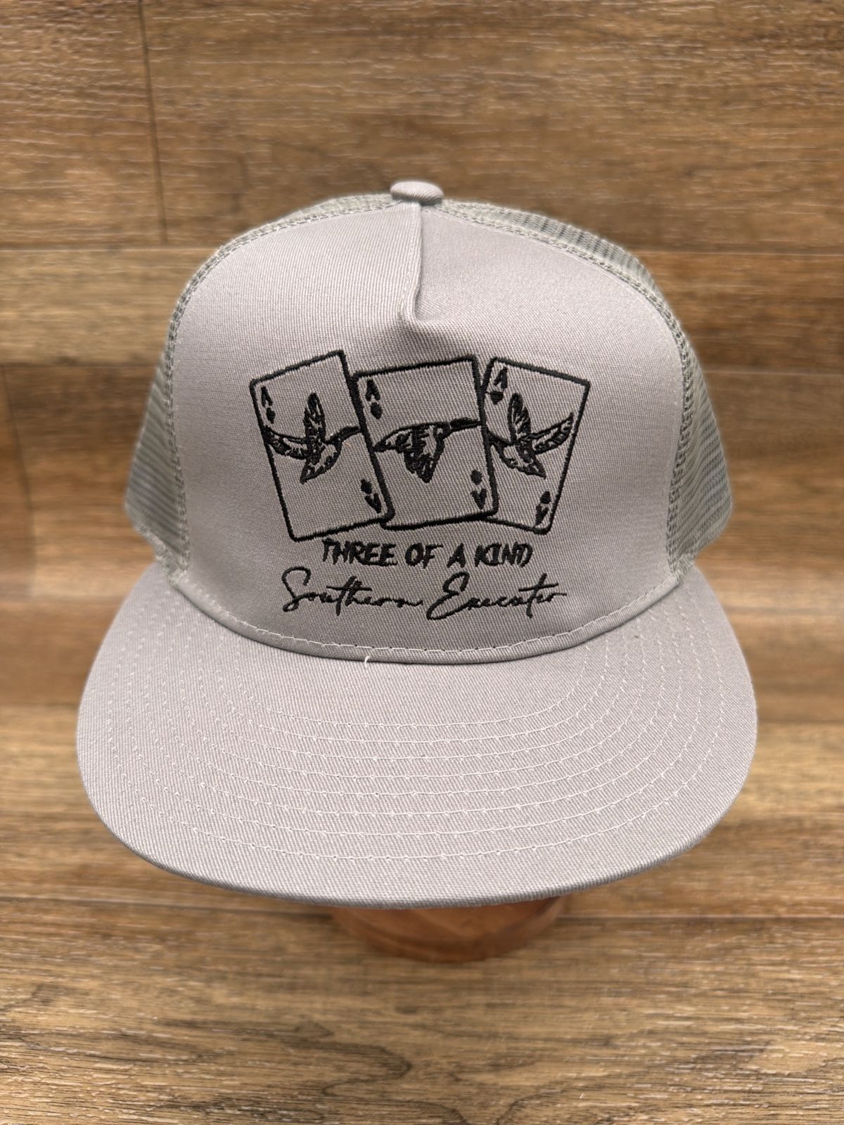 Three of a Kind flat brim trucker cap in Gray by Southern Executer, front