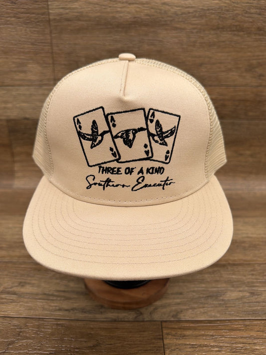 Three of a Kind flat brim trucker cap in Tan by Southern Executer, front